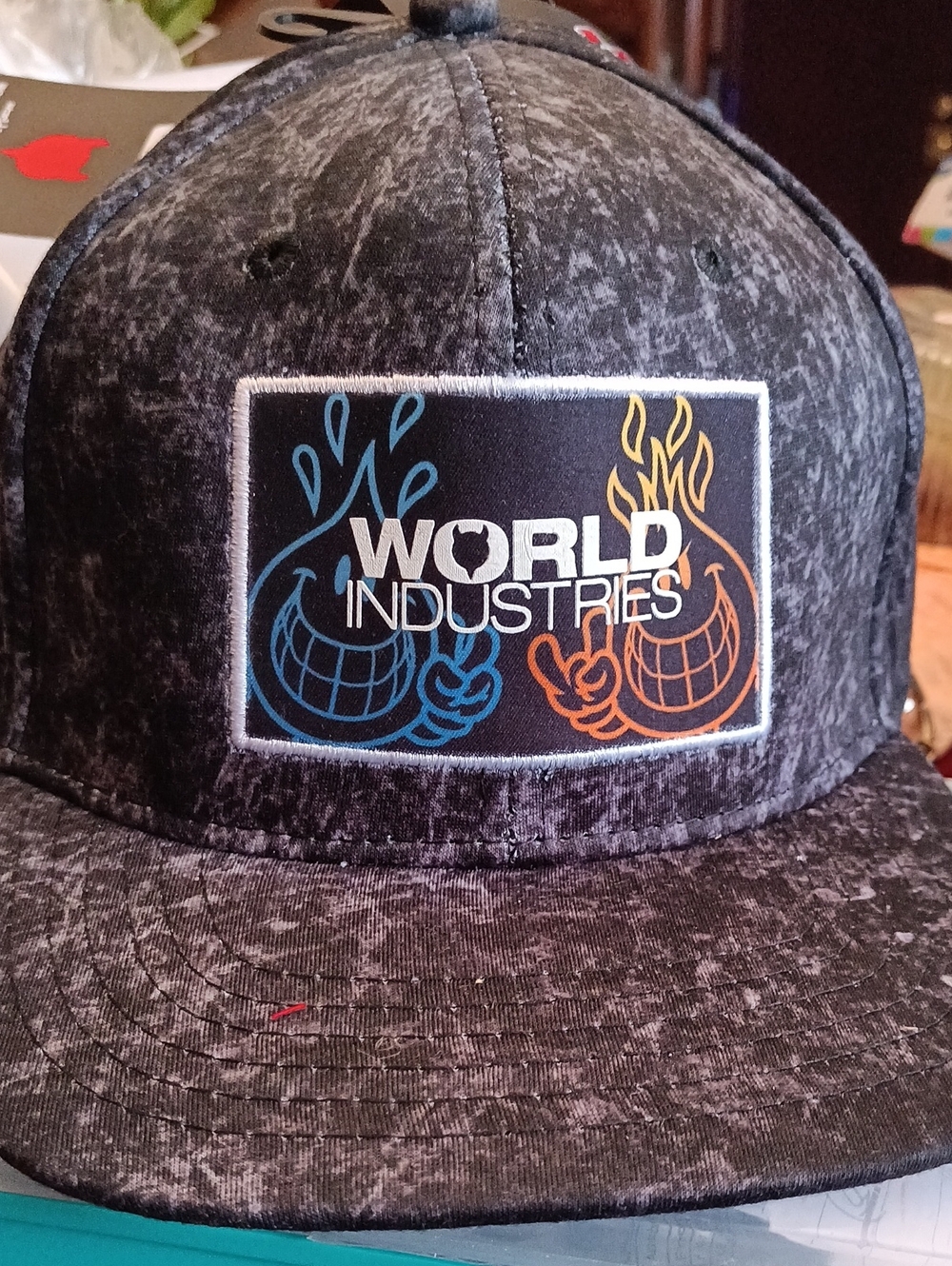 World Industries black acid wash snapback hat featuring an embroidered patch